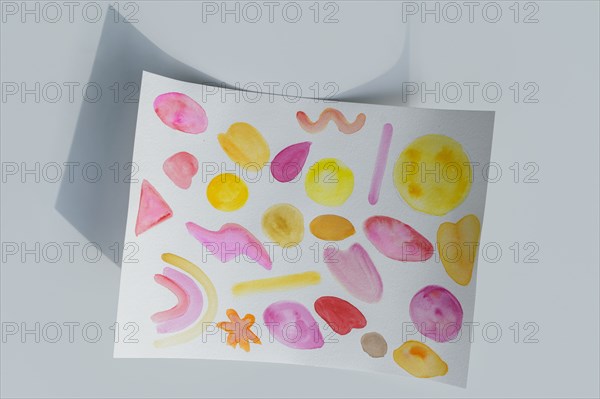 Studio shot of paper with colorful painted pattern