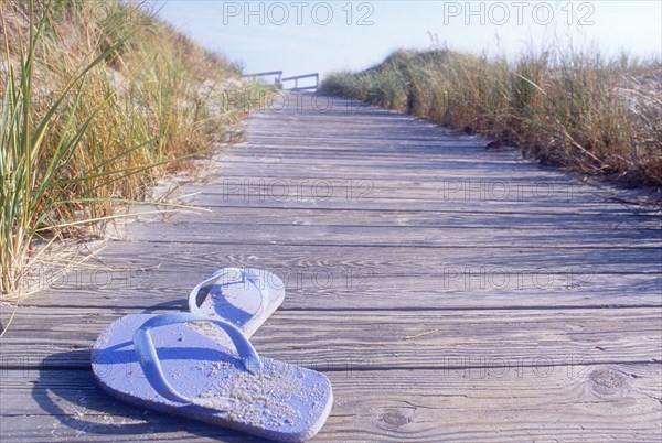 Flip flops on boardwalk to beach