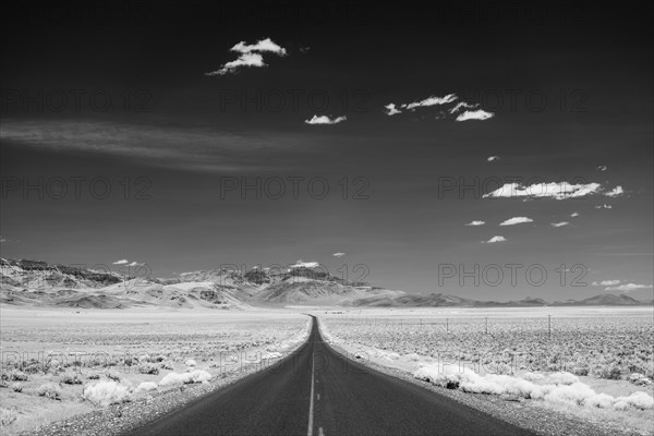 Empty road crossing desert landscape