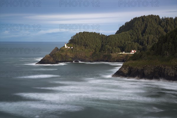 Seascape with green peninsula and lighthouse