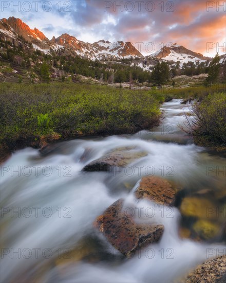 Waterfall on stream with mountain range in background