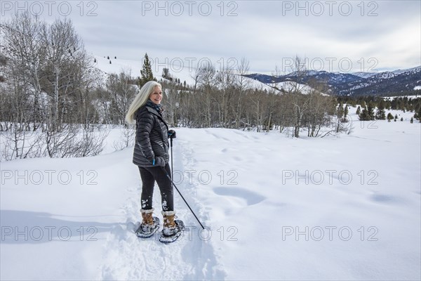 Senior woman snowshoeing