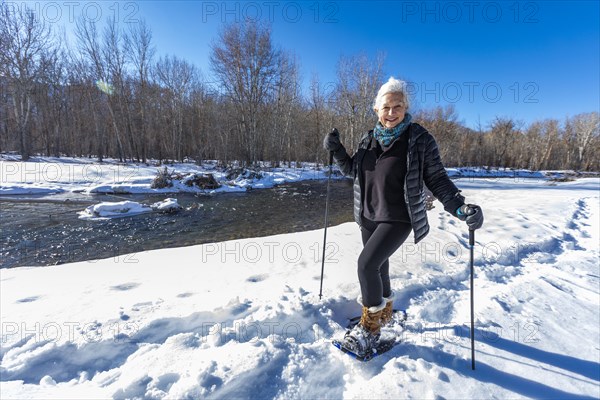 Senior woman snowshoeing