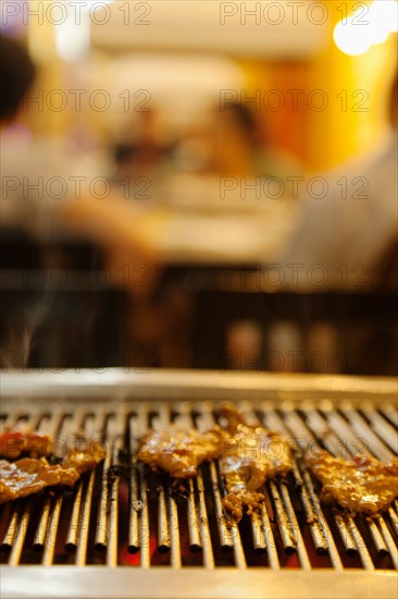 Meat cooking on grill