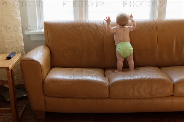 Baby boy playing on sofa