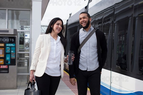 Young couple on platform with light train