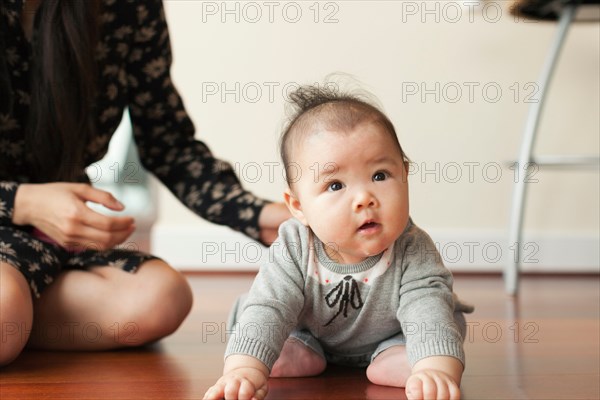 Baby girl sitting on floor