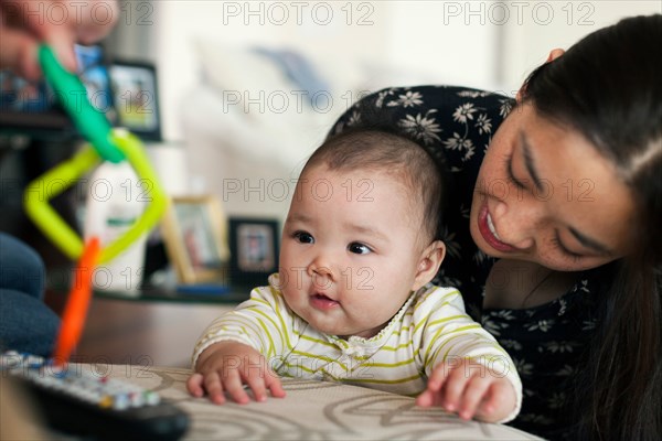 Close up of parents playing with baby daughter