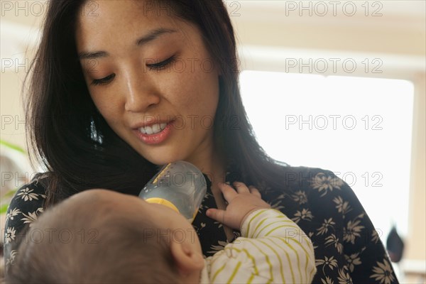 Close up of mother feeding baby daughter