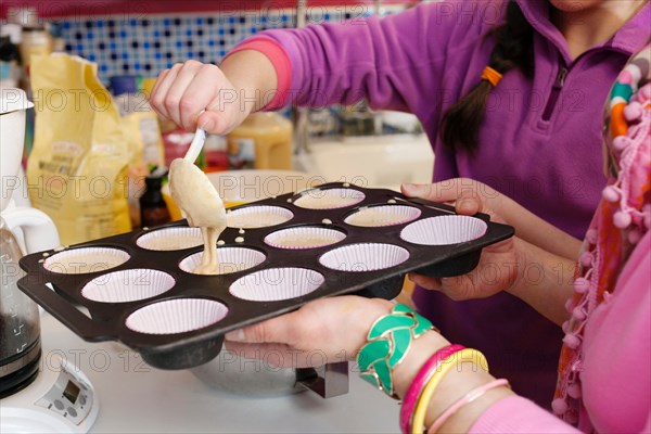 Mother and daughter making cupcakes