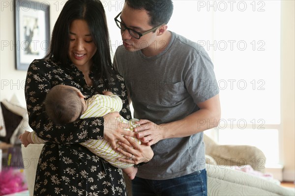 Parents holding baby girl