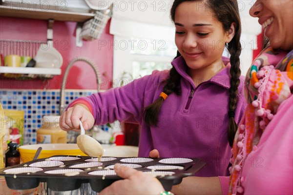 Mother and daughter making cupcakes