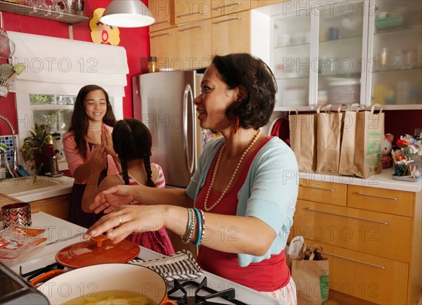 Mother and daughters in kitchen