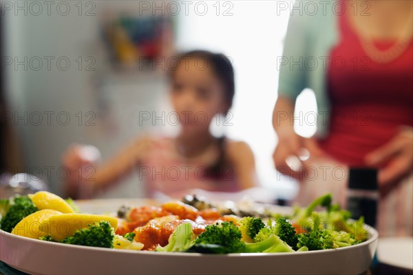 Dish of broccoli and lemon pieces in tomato sauce