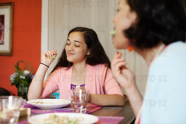 Mother and daughter having meal together