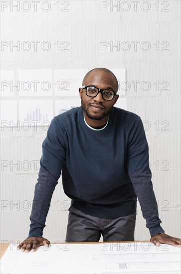 Portrait of young businessman in design office