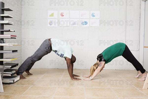 Young business partners exercising in design office