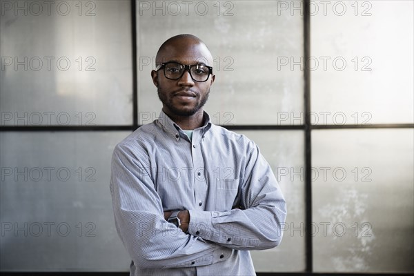 Portrait of young interior designer in empty room