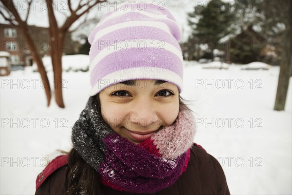 Portrait of teenage girl wrapped up for winter snow
