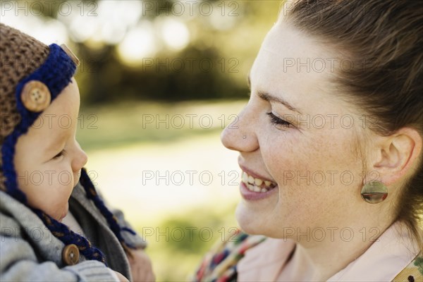 Portrait of mid adult mother and baby son in park