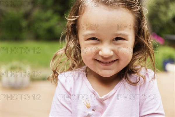 Close up portrait of smiling female toddler in garden