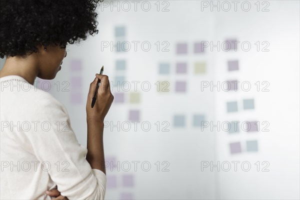 Young woman holding pen