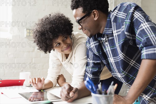 Young couple working on digital tablet