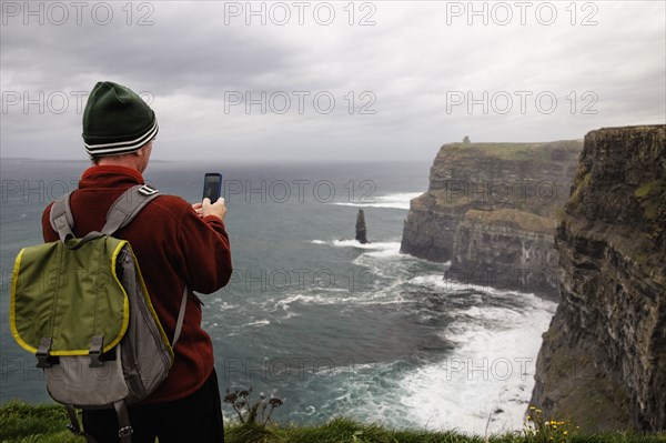 Mid adult man taking photo