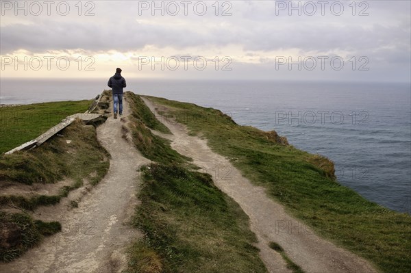 Mid adult man walking on path