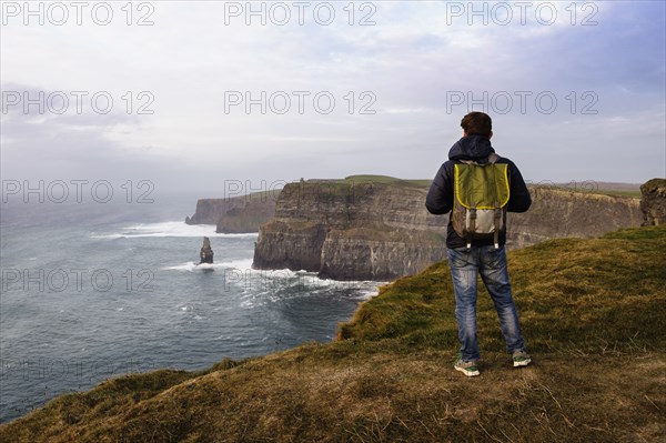 Mid adult man standing on The Cliffs of Moher