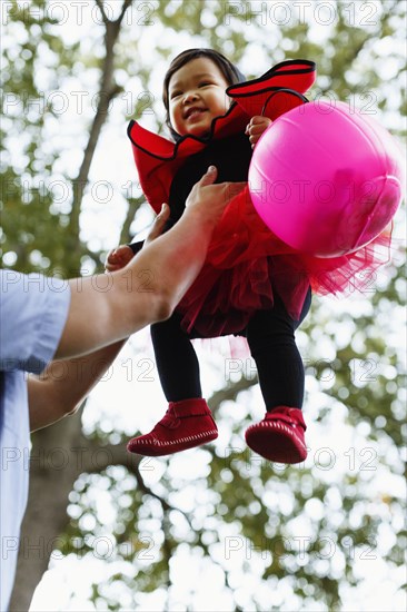 Father lifting daughter into the air