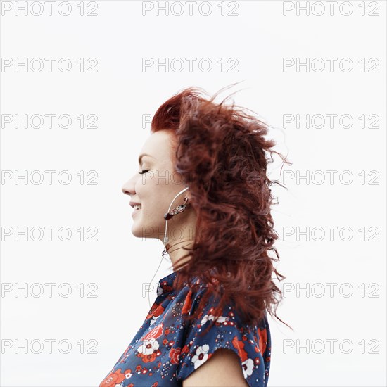 Profile of young woman with long red hair