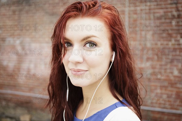 Portrait of young woman with long red hair