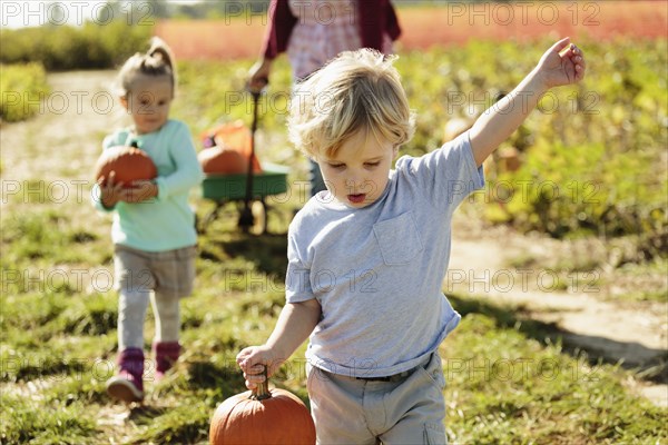 Boy carrying pumpkin