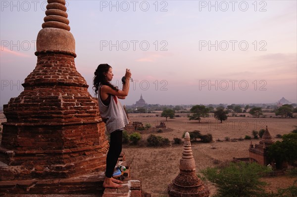 Woman taking photograph of view
