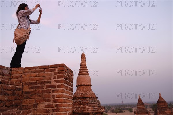 Woman taking photograph of view