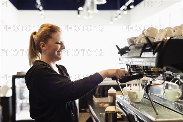 Coffee shop barista making coffee