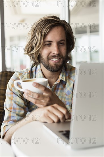 Mid adult man in coffee shop