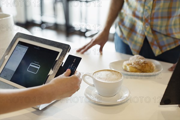 Customer paying for coffee in coffee shop