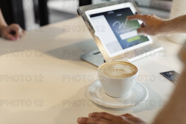 Customer paying for coffee in coffee shop