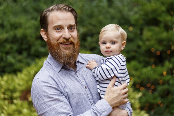 Portrait of father holding baby girl