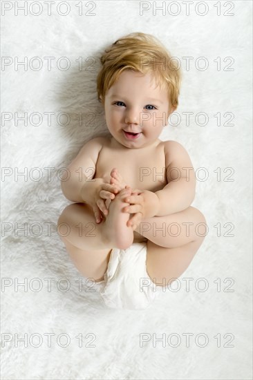 Toddler lying on blanket