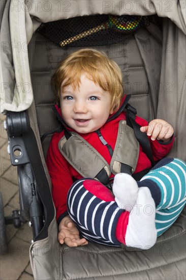 Toddler sitting in pushchair