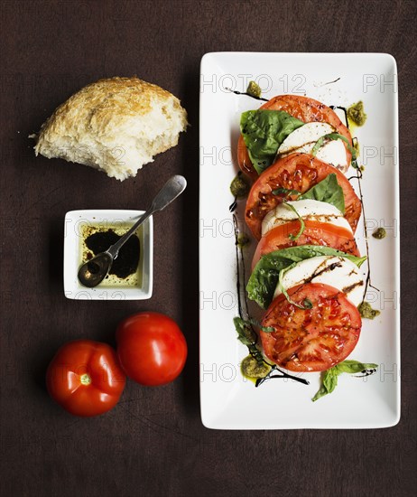 Sliced vine tomatoes and mozzarella with basil and bread