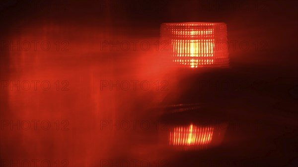 Close-up of flashing red emergency light at night