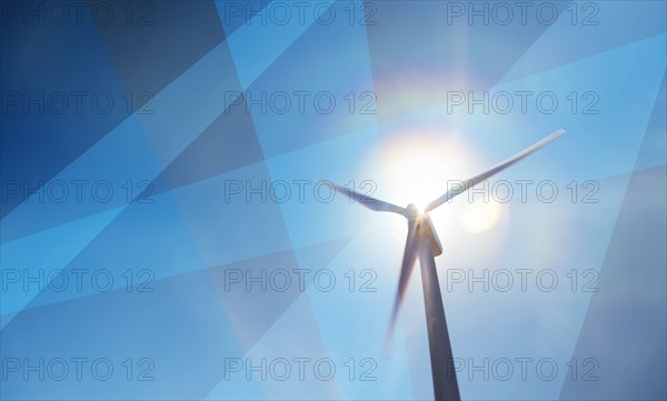 Wind turbine against sky and sun