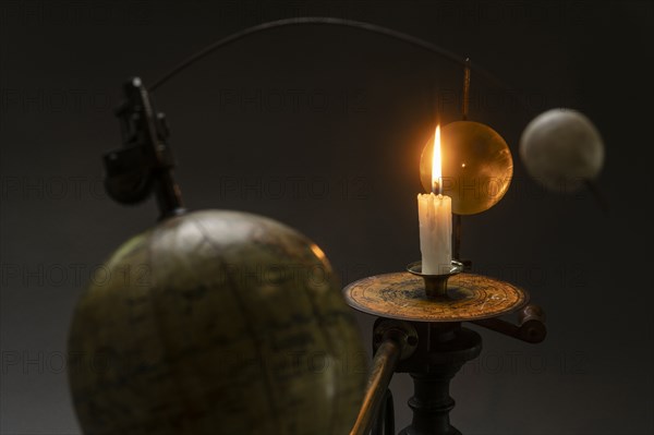 Antique globe and candle solar system model