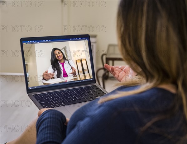 Woman having video call with doctor