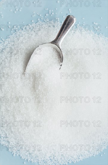 Studio shot of heap of sugar and scoop