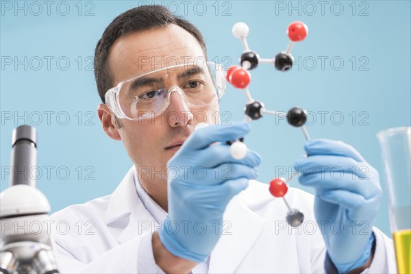 Scientist holding molecule model